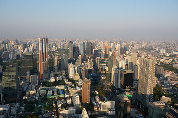 Fototapeta premium Stunning daytime aerial view of dense urban sprawl and architectural design of modern skyscrapers in the business district of Bangkok Thailand