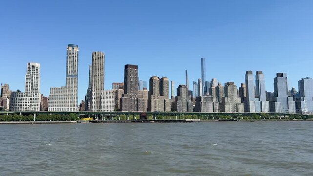 Scenic panoramic Upper West Side shore vista on a sunny summer day viewed from a boat, New York City