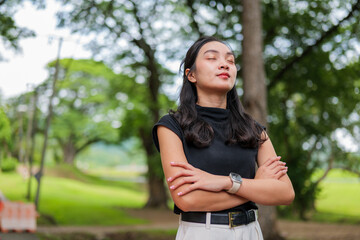 Fototapeta premium Young woman relaxing outdoors feeling calm and serene