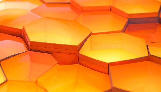 Close-up view of an arrangement of orange, pentagonal panels with varying light and shadows