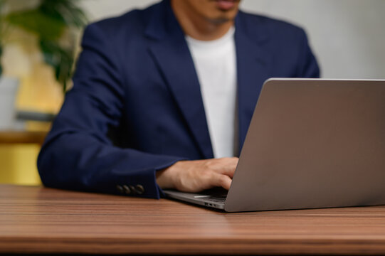 Business Professional Working on Laptop in Modern Office Setting