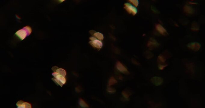 Sparkle blink. Blur flare gleam. Defocused yellow color glow flicker blaze lens glimmer shine on abstract bokeh effect dark black art background.