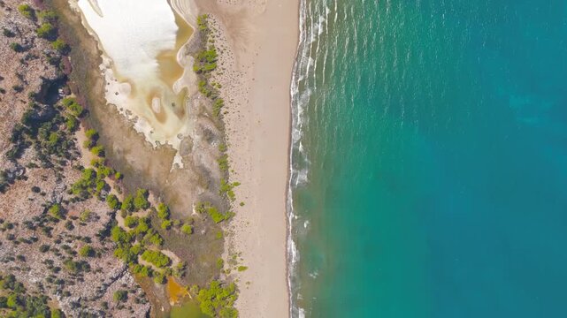 Dalyan, Turkey. Iztuzu Turtle Beach, a narrow sandy spit between turquoise Mediterranean waters and the Dalyan River delta, aerial drone view along the protected shoreline. Aerial View, HEAD OVER SHO