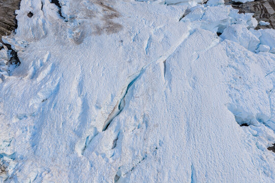 Aerial View of Glacier Ice Field With Crevasses and Snow Texture in BC, Canada Coast Mountains