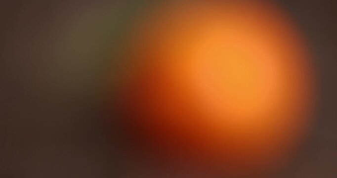 juicy ripe orange tangerine with one green leaf, fruit on a wooden table, unpeeled ripe orange-skinned small tangerine with a long green leaf