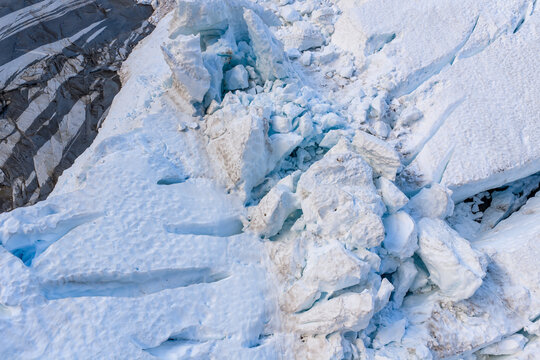 Aerial View Of Glacier Ice Crevasse And Broken Seracs On Rocky Glacier Edge In British Columbia
