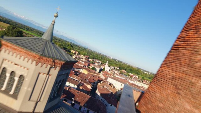 Bell tower of Pieve di Santa Maria Assunta in historic town of Soncino, Italy. Aerial forward, spin shot, copy space