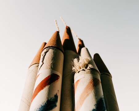 Patriotic bottle rockets with fuse details and striped patterns arranged in a cluster for holiday event planning, explosive product retail and firework safety awareness