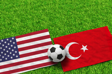 American and Turkish flags with a soccer ball on green grass © MdFiroj