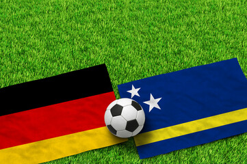 Fototapeta premium German and Solomon Islands flags with soccer ball on green grass