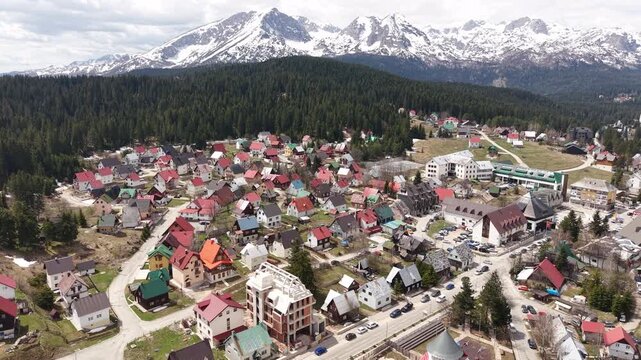 Drone Shot of Zabljak Town Under Peaks of Durmitor Mountain, Montenegro, Ski Resort in Summer Season