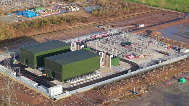 Detailed aerial view focusing on synchronous compensator buildings and high voltage transformer infrastructure