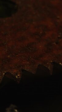 Vertical Horror concept: Detailed macro dolly of a rusty and filthy saw and bloody ropes