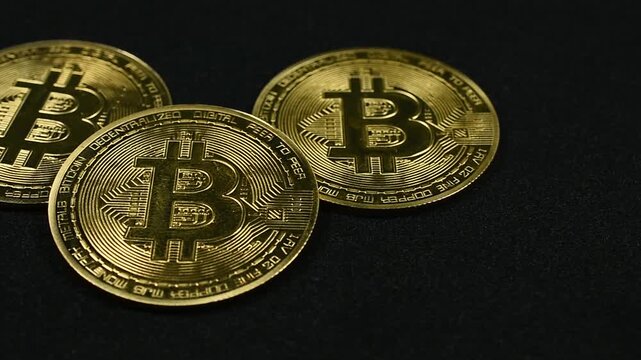 Pan Across Gold Bitcoins on Black Background