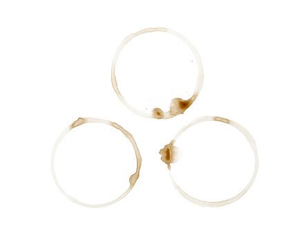 A high-quality image featuring three circular coffee or tea cup stain stains with brown edges and white interiors, arranged in a triangular formation On Transparent Background