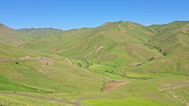 A peaceful spring valley with rolling green hills and a winding road under a bright blue sky, showcasing calm rural nature.
📍 Marivan, Kurdisatn, Iran 