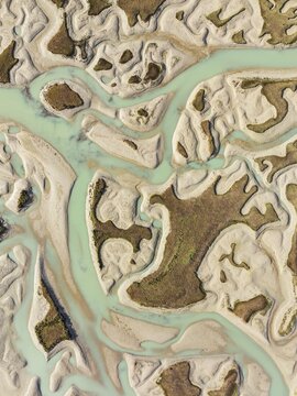Network of channels and streams at low tide. In the marshland of the Bah&iacute;a de C&aacute;diz Nature Reserve. Aerial view. Drone shot. C&aacute;diz province, Andalusia, Spain