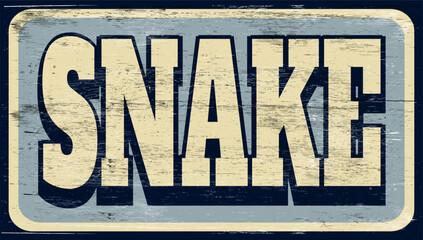 Aged and worn snake sign on wood © jdoms