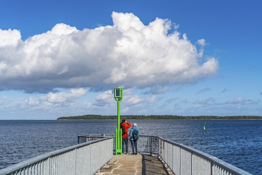 People on the pier at the Utkiek lookout in the fishing village of Wieck with a view over the Greifswald Bodden, Greifswald, Mecklenburg-Western Pomerania, Germany