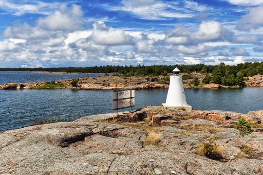 Coastline with lighthouse on rocks, sunny weather, K&auml;ringsund, Fasta &Aring;land, Aland Islands, Aland Islands, Finland