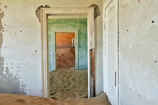 Desert sand in the ruined building of the former diamond city, ghost town, Kolmanskop, L&uuml;deritz, Namibia