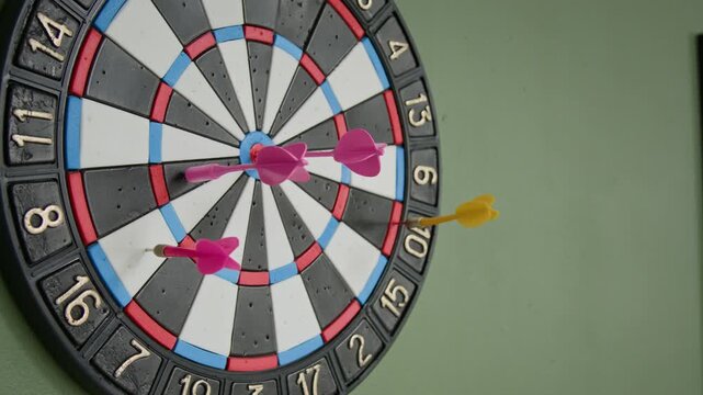 No people close-up of darts game hanging on wall at technology startup company office, suggesting employee recreation, entertainment, competition and fun relaxing activity during workday
