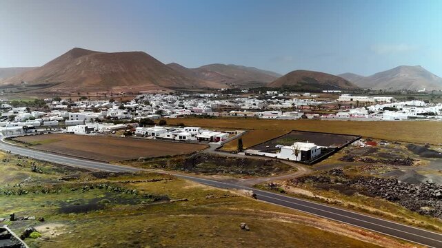 Aerial drone shot circling the white town of Uga, Lanzarote