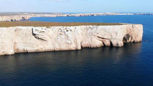 Seaside Limestone Towering Formations. Chalky Seaside Escarpment With Caves And Layered Strata Visible. Media