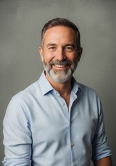 Obraz premium Confident Smiling Mature Businessman with Grey Beard in Professional Studio Portrait