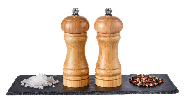 Wooden pepper and salt grinders with peppercorns and salt crystals