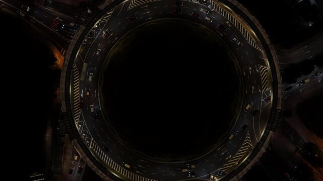 Rotunda Park roundabout in Macau at night, flying upwards