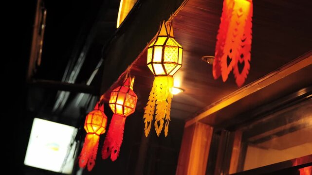 Traditional lantern decorations shining outside, nighttime restaurant scene