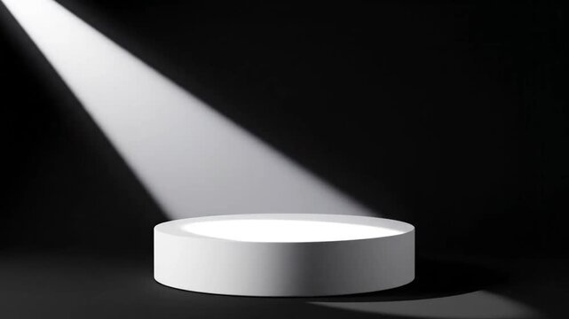 A minimalist cylindrical white podium or pedestal illuminated by a bright, sharp beam of white light from above against a stark, deep black background creating a dramatic spotlight effect
