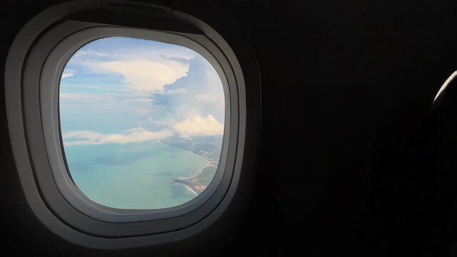 Scenic Tropical Coastline Through Airplane Window During Flight.