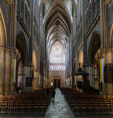 Fototapeta premium Metz Cathedral nave toward rose window with chairs, France
