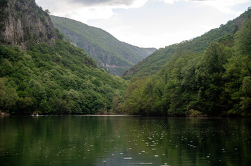 Fototapeta premium Matka Canyon view with reflection on water in Skopje, North Macedonia during cloudy day