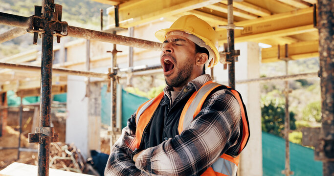 Tired, man and construction worker with yawn on site for burnout, overtime or fatigue with building. Exhaustion, renovation deadline and male civil engineer by infrastructure with stress for repairs.