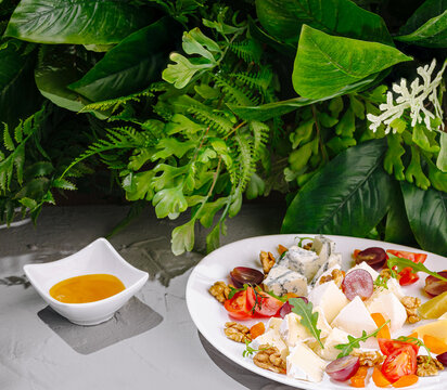 Gourmet Cheese Platter Served With Honey And Walnuts