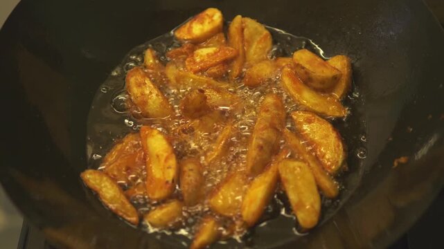 Golden Fried Plantains Sizzling in Wok With Hot Oil and Crispy Edges Cooking on Stove in England UK