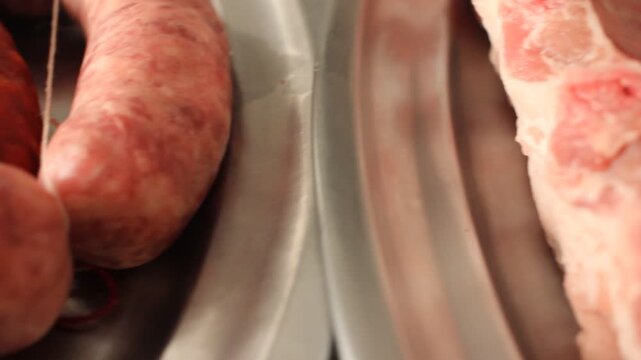 Close up of raw pork sausages and beef ribs prepared for a barbecue