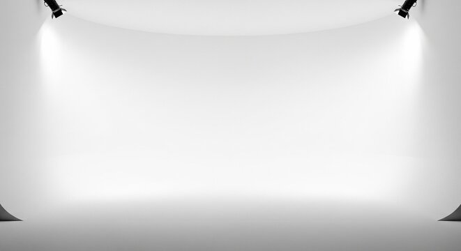 Empty photography studio with white cyclorama wall and stage spotlights