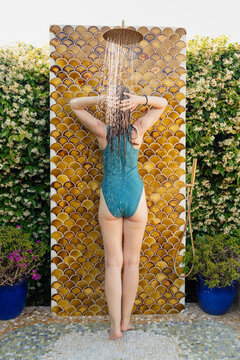 Woman Taking Outdoor Shower in Luxury Villa, Porto Cervo, Sardinia