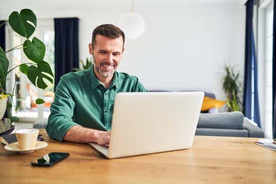 Mature businessman working from home using laptop