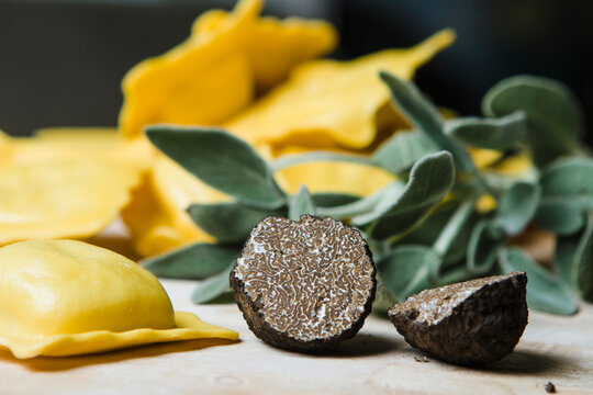 Sliced black truffle, sage and homemade ravioli filled with black truffle and sage