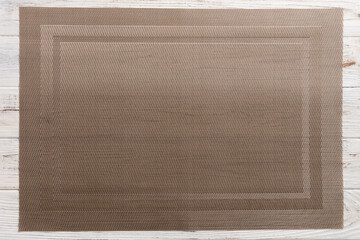 Obraz premium Top view of brown tablecloth for food on wooden background. Empty space for your design