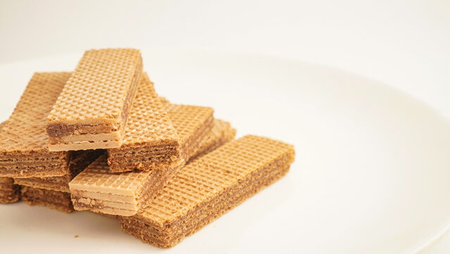Sweet wafers filled with chocolate and vanilla cream isolated on a white background