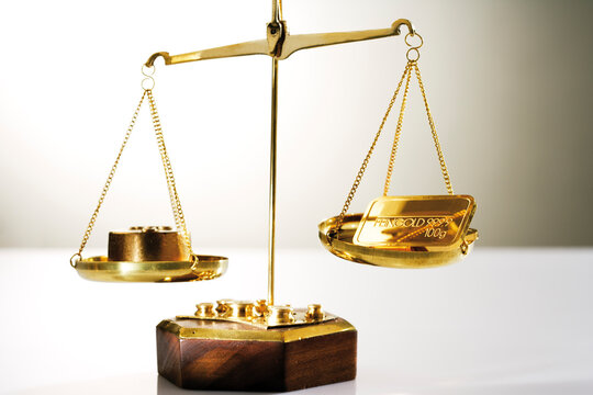 Gold bar on a a pair of scales