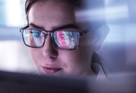 Young IT support working over biometric data on computer