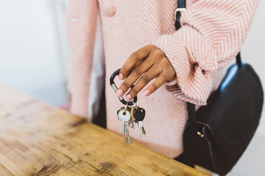 Woman coming home, putting keys on table