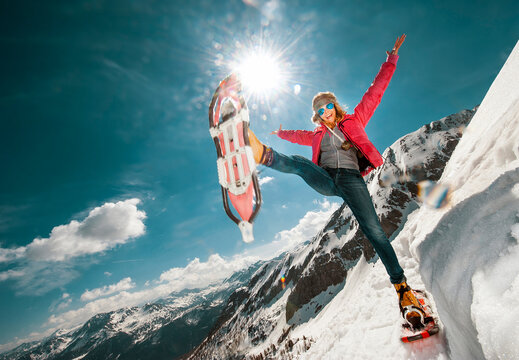 Austria, Salzburg County, Young woman snowshoeing in the mountains